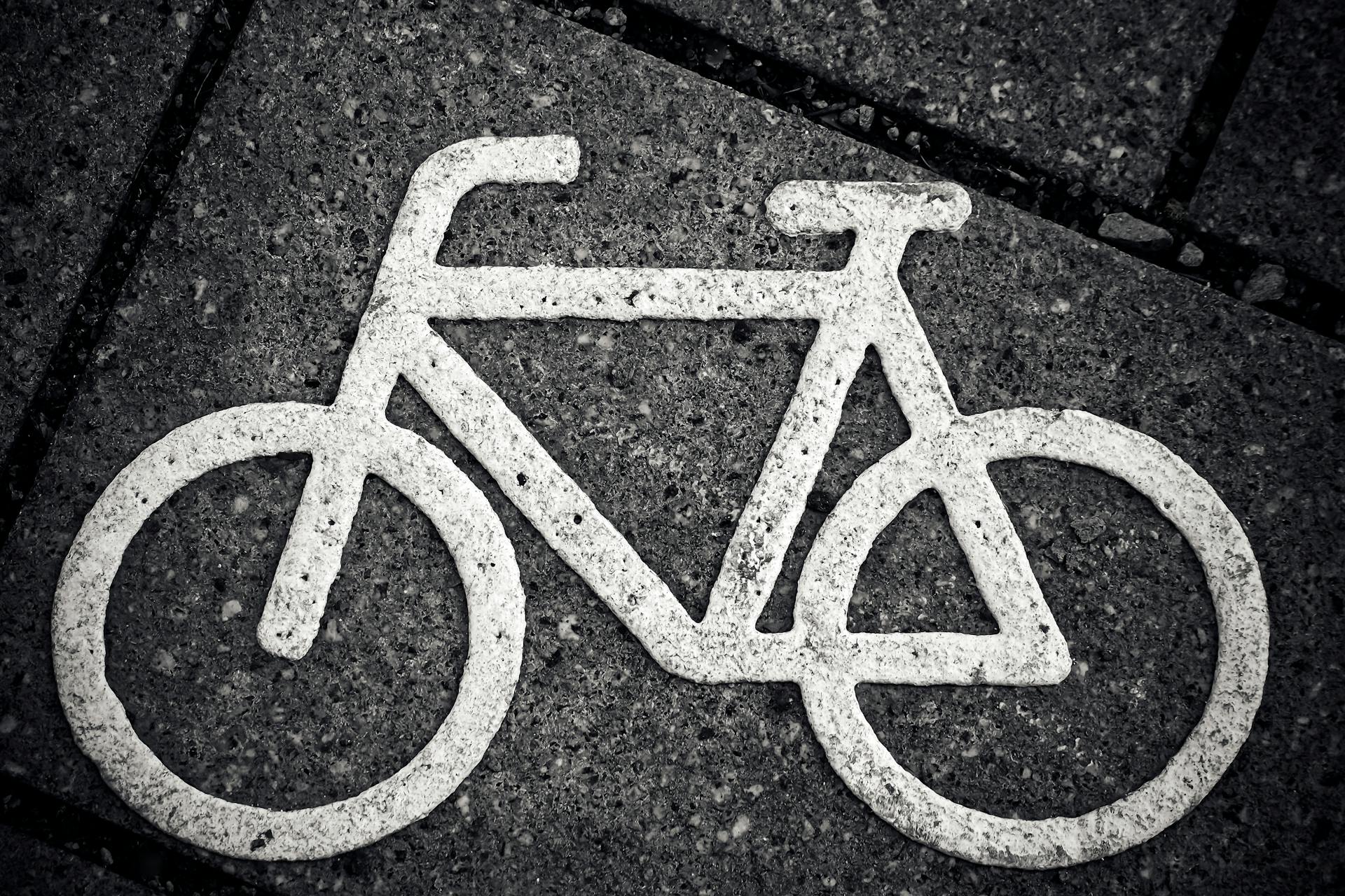 a white bicycle logo painted on the floor